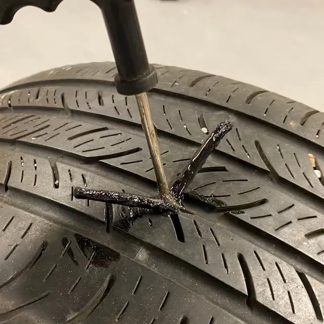 Tire puncture being repaired